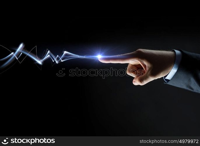 business, people and connection concept - close up of businessman finger connecting to lightning over black background. businessman finger connecting to lightning