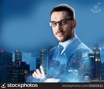 business, people and corporate concept - businessman in glasses over night singapore city skyscrapers background and virtual charts. businessman in glasses over night singapore city