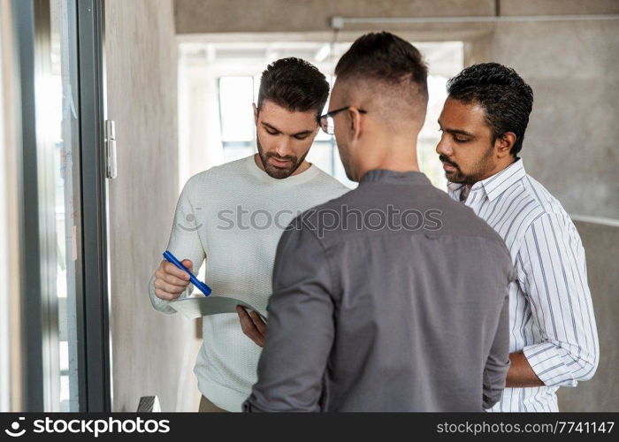 business, people and corporate concept - businessmen with folder working at office. businessmen with folder working at office