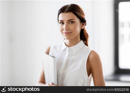 business, people and corporate concept - businesswoman or realtor with folder at office. businesswoman or realtor with folder at office. businesswoman or realtor with folder at office