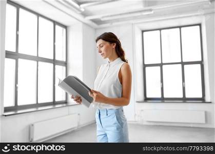 business, people and corporate concept - businesswoman or realtor with folder reading documents at office. businesswoman or realtor with folder at office