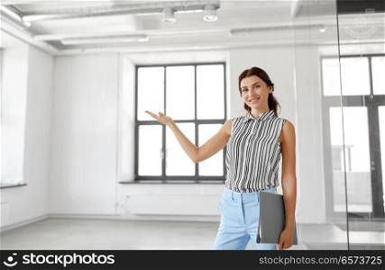 business, people and corporate concept - businesswoman or realtor with folder showing new office room. businesswoman or realtor with folder at office