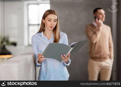 business, people and corporate concept - female office worker with folder. female office worker with folder. female office worker with folder