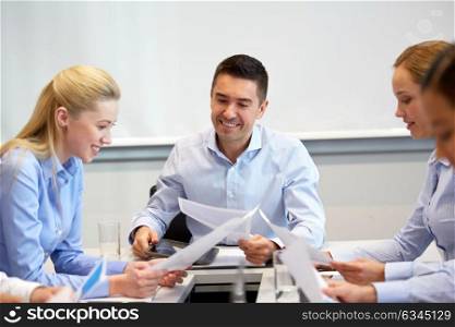 business, people and corporate concept - happy coworkers with papers working at office. happy business team with papers at office