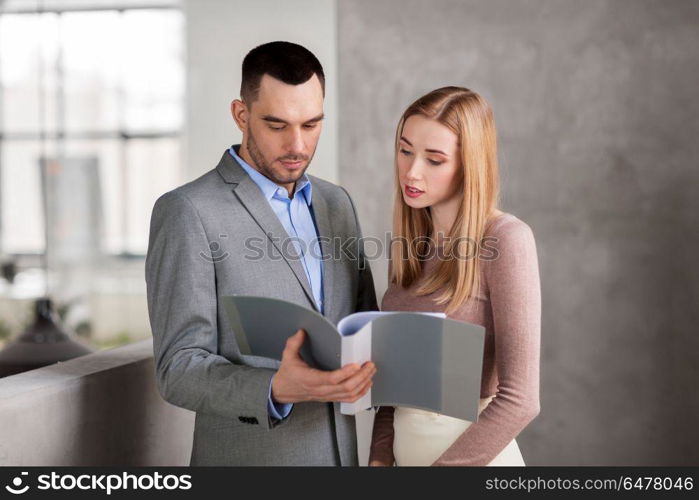 business, people and corporate concept - happy smiling businesswoman and businessman with folder at office. businesswoman and businessman with folder. businesswoman and businessman with folder