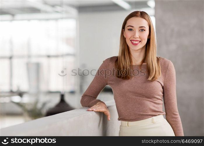 business, people and corporate concept - happy smiling businesswoman at office. happy smiling businesswoman at office