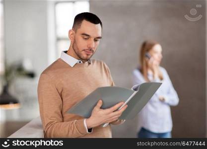 business, people and corporate concept - male office worker with folder. male office worker with folder. male office worker with folder