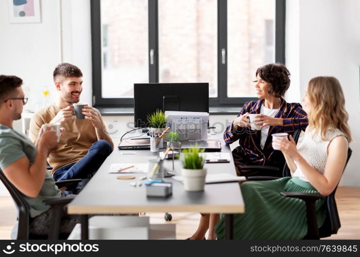 business, people and corporate concept - team of startuppers drinking coffee at office. team of startuppers drinking coffee at office