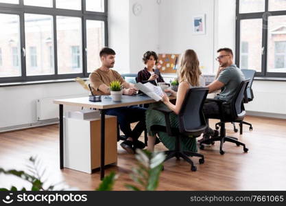 business, people and corporate concept - team of startuppers or ui designers working at office. business team or startuppers working at office