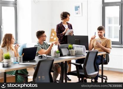 business, people and corporate concept - team of startuppers working at office. business team or startuppers working at office