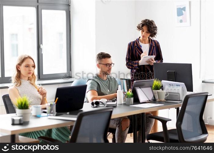 business, people and corporate concept - team of startuppers working at office. business team or startuppers working at office