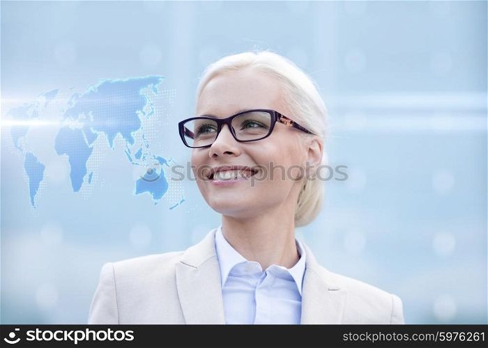 business, people and education concept - young smiling businesswoman with world map hologram outdoors