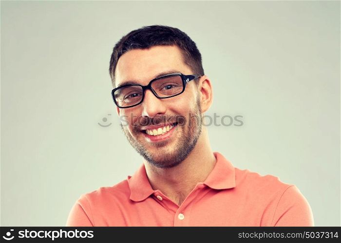 business, people and eyesight concept - portrait of happy smiling man in eyeglasses over gray background. portrait of happy smiling man in eyeglasses