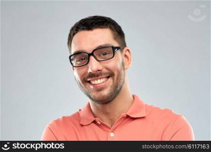 business, people and eyesight concept - portrait of happy smiling man in eyeglasses over gray background