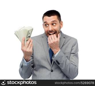 business, people and finances concept - astonished businessman with bundle of american dollar cash money. smiling businessman with american dollar money