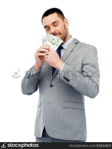 business, people and finances concept - businessman smelling american dollar money. businessman smelling american dollar money