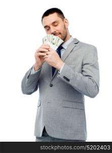 business, people and finances concept - businessman smelling american dollar money. businessman smelling american dollar money