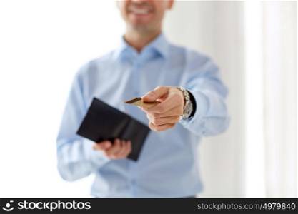 business, people and finances concept - close up of businessman with credit card and wallet. close up of businessman with credit card