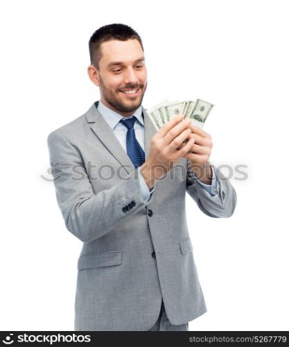 business, people and finances concept - smiling businessman counting american dollar money. smiling businessman counting american dollar money