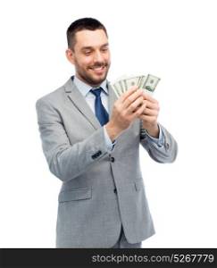 business, people and finances concept - smiling businessman counting american dollar money. smiling businessman counting american dollar money
