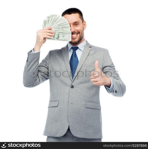 business, people and finances concept - smiling businessman with american dollar money showing thumbs up. smiling businessman with money showing thumbs up
