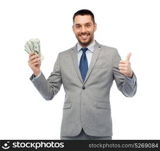 business, people and finances concept - smiling businessman with bundle of american dollar cash money showing thumbs up. smiling businessman with american dollar money