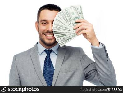 business, people and finances concept - smiling businessman with bundle of american dollar cash money. smiling businessman with american dollar money