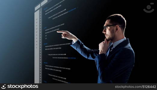 business, people and future technology concept - businessman in glasses with coding on virtual screen over black background. businessman with coding on virtual screen