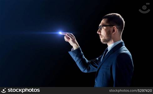 business, people and future technology concept - businessman in suit and glasses with laser light over black background. businessman in glasses with laser light over black