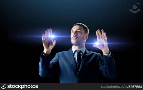 business, people and future technology concept - businessman in suit with laser lights over black background. businessman with laser light over black