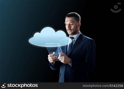 business, people and future technology concept - businessman in suit working with transparent tablet pc computer and cloud computing hologram over black background. businessman working with transparent tablet pc