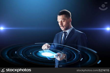 business, people and future technology concept - businessman in suit working with transparent tablet pc computer and virtual projection over black background. businessman in suit with transparent tablet pc