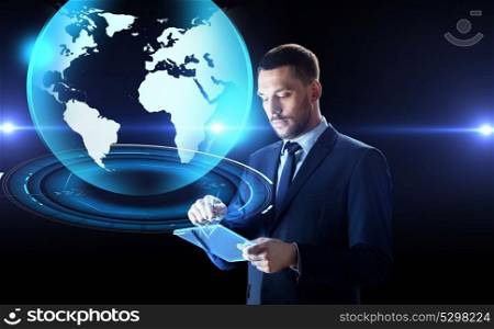 business, people and future technology concept - businessman in suit working with transparent tablet pc and virtual earth hologram computer over black background. businessman with tablet pc and earth hologram