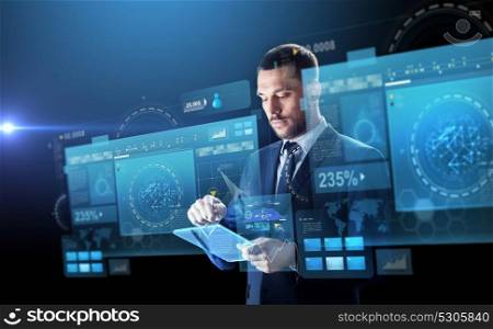 business, people and future technology concept - businessman in suit working with transparent tablet pc computer and virtual screens projection over black background. businessman in suit with transparent tablet pc