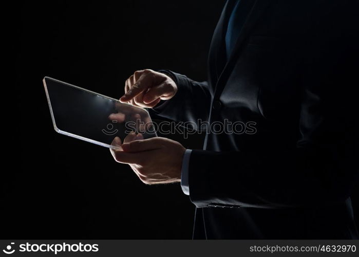 business, people and future technology concept - close up of businessman hands with transparent tablet pc computer over black