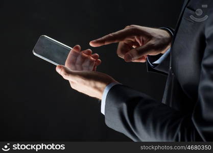 business, people and future technology concept - close up of businessman hands with transparent smartphone over black