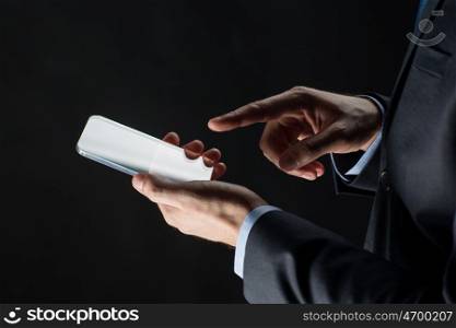 business, people and future technology concept - close up of businessman hands with transparent smartphone over black