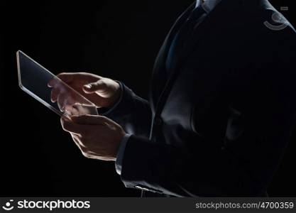 business, people and future technology concept - close up of businessman hands with transparent tablet pc computer over black
