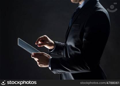 business, people and future technology concept - close up of businessman hands with transparent tablet pc computer over black
