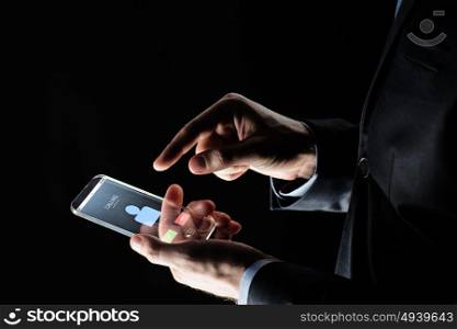 business, people and future technology concept - close up of businessman hands with incoming call on transparent smartphone over black background. close up of hands with incoming call on smartphone
