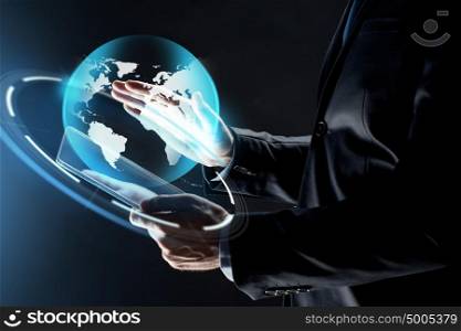 business, people and future technology concept - close up of businessman hands with transparent tablet pc computer and earth projection over black background. close up of businessman with transparent tablet pc