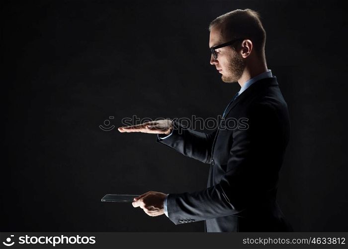 business, people and future technology concept - close up of businessman with transparent tablet pc computer over black