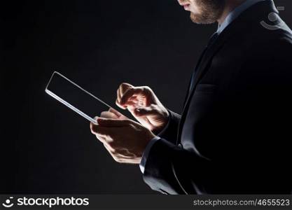 business, people and future technology concept - close up of businessman with transparent tablet pc computer over black