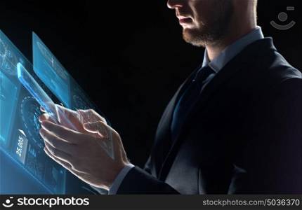 business, people and future technology concept - close up of businessman with transparent tablet pc computer and virtual screen projection over black background. close up of businessman with transparent tablet pc