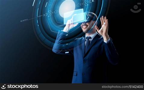 business, people and future technology concept - smiling businessman in virtual headset over black background with hologram. businessman in virtual reality headset over black