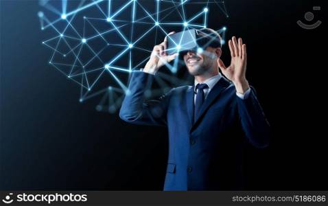 business, people and future technology concept - smiling businessman in virtual headset over black background with low poly shape projection. businessman in virtual reality headset over black