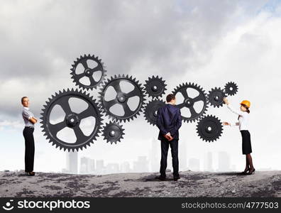 Business people and mechanism elements. Businessman and businesswoman with cog wheel elements. Organization concept