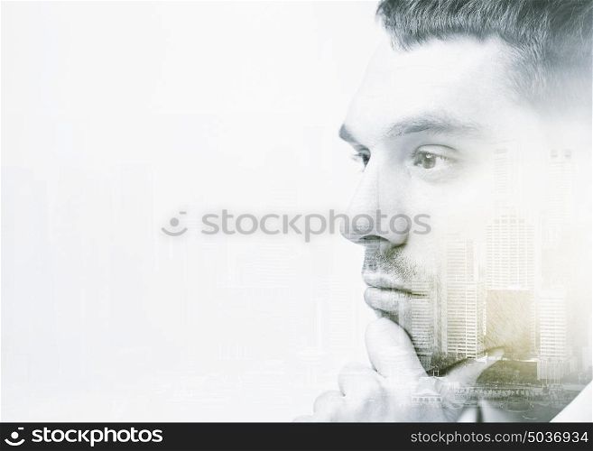 business, people and mind concept - close up of male face over city buildings and double exposure effect. close up of male face