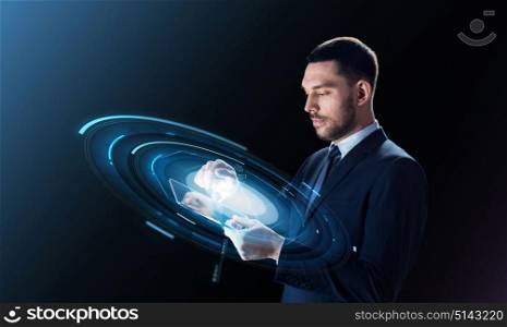business, people and modern technology concept - businessman in suit working with transparent tablet pc computer and virtual projection over black background. businessman with tablet pc and virtual projection