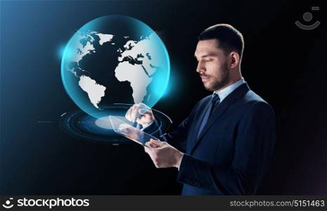 business, people and modern technology concept - businessman in suit working with transparent tablet pc computer and virtual earth projection over black background. businessman with tablet pc and earth projection
